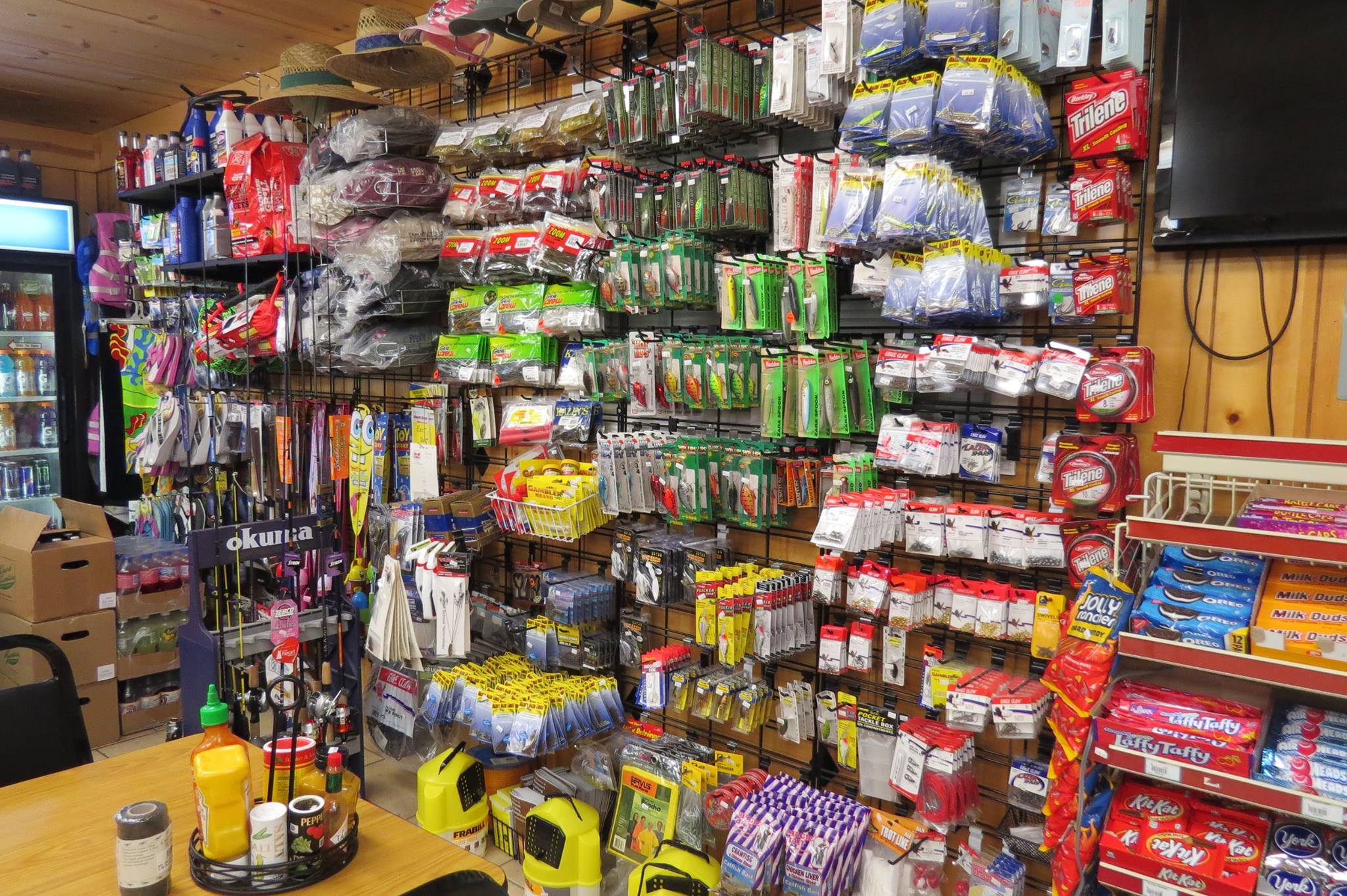 General store wall stocked with fishing tackle and candy