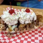 Loaded ice cream sundae with whipped cream and cherries