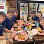 Group of teenage boys enjoying lunch at a restaurant table