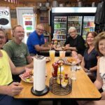 Group of friends enjoying a casual meal at a restaurant table